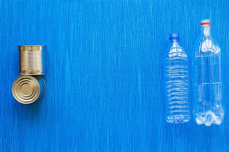 Recycling. Materials for recycle and reuse plastic bottle, tin can on blue background. Top view....
