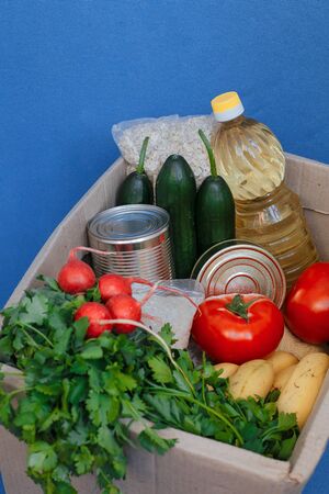 Donation box with food on a blue backgroundの写真素材