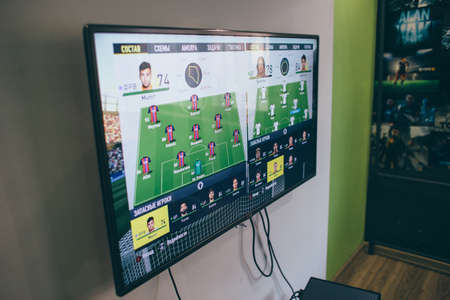 TV with the image of the game on FIFA Russian version on the Microsoft Xbox, a video game console.のeditorial素材