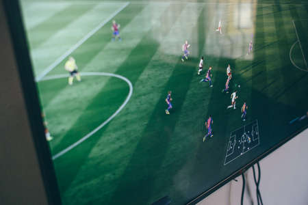 TV with the image of the game on FIFA Russian version on the Microsoft Xbox, a video game console.のeditorial素材