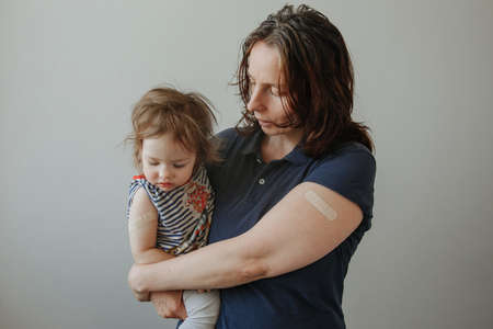 mother and daughter, a child after vaccination. A child with poor health and a high temperature.