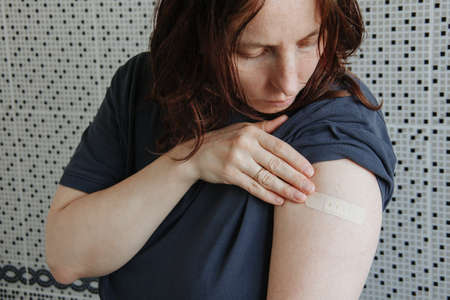 Vaccinated Woman Showing Arm After Vaccine Injectionの写真素材