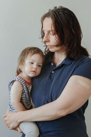mother and daughter, a child after vaccination. The woman makes a stop gesture. Stop viruses concept