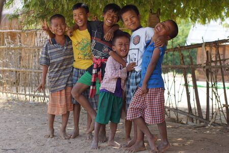 Bagan Burma, Myanmar November 11, 2012. Portrait of six happy smiling Burmese boys different age in colorful clothesのeditorial素材