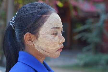 Bagan, Burma Myanmar - December 3, 2012. Side portrait of young Burmese girl with thanaka cosmetic on faceのeditorial素材
