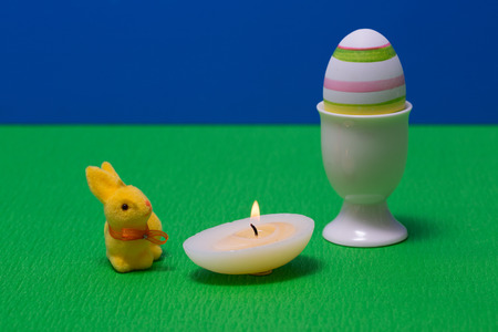 Easter egg with beautiful motive with candle and bunny.