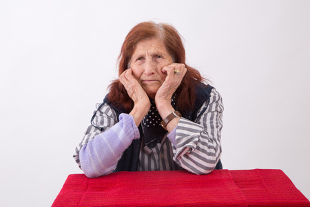 Portrait of an elderly woman with sad face expression.の写真素材