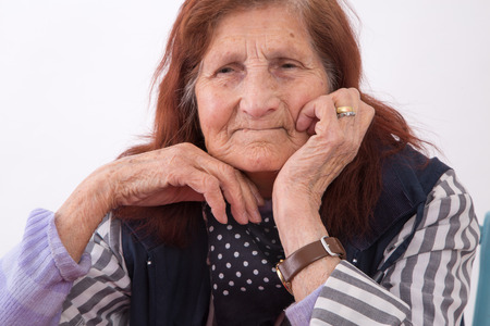 Portrait of an elderly woman with satisfied face expression.