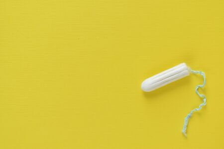 Female swab isolated on a yellow background.の写真素材