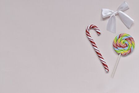 On the right are two bright multi-colored sweets of different shapes with a bow.の写真素材