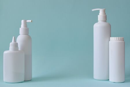 Jar with baby powder, bottle of talcum powder, liquid soap and shower gel isolated on a blue background. Body care. Spa Relax Baby hygiene.の写真素材