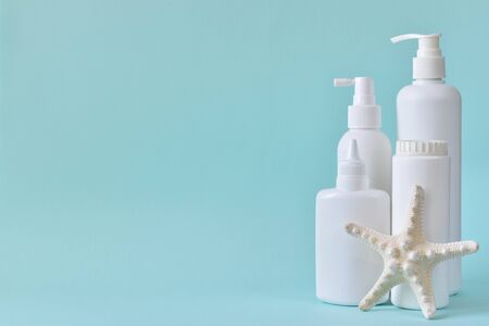 Jar with baby powder, bottle of talcum powder, liquid soap and shower gel, starfish isolated on a blue background. Body care. Spa Relax Baby hygiene.の写真素材