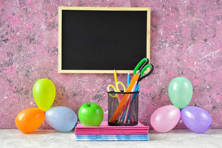 Back to school. School board on a pink background there is a place for text. Holiday September 1.