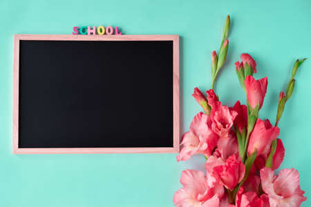 Back to school. School board with place for text and a bouquet of gladioli.の写真素材
