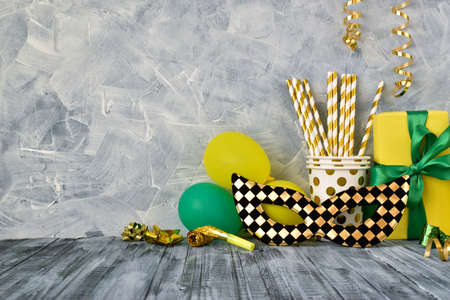 One black-and-gold mask and various accessories for parties