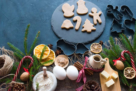Christmas background. On a dark background are various items for making cookies and gingerbread....