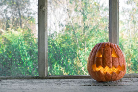 Halloween pumpkin on the old windowsill.の写真素材