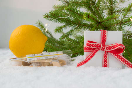 Medical bath, gift box, thermometer and Christmas tree on a snowy background. Copyspace. Medication....