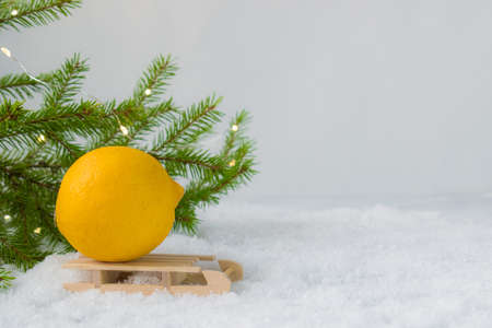 Lemon is lying on a wooden sled. Prevention of colds.の写真素材