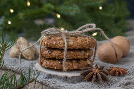 Christmas cookies on the background of a Christmas tree. Oatmeal cookies close-up. Nuts. Happy New...