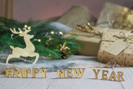 Christmas composition on a wooden background with gold letters space for text. Happy New year and merry Christmas.の写真素材