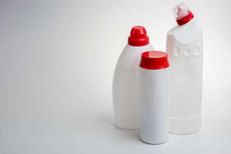 Three bottles of household chemicals on a white background.の写真素材
