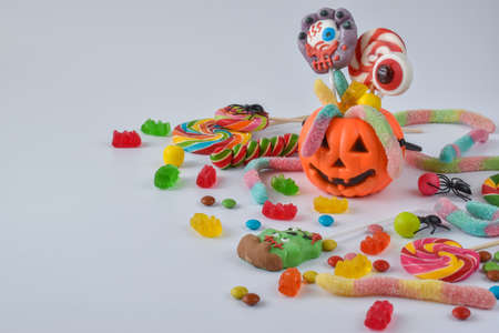 Basket in the form of a pumpkin with various candies. Holiday chores