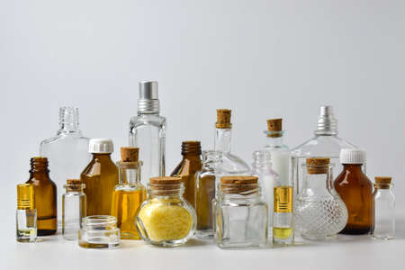 Empty glass bottles on a light background. Various vessels for cosmetics and medicines.の写真素材