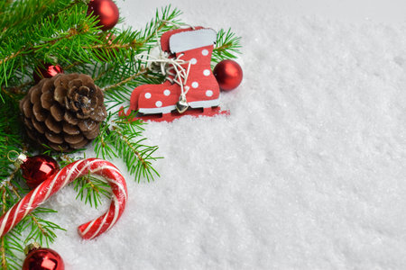 Fir branches with red Christmas balls and cones with candy and skates Happy New year and Christmas....