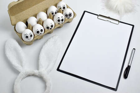 Painted eggs with a sign next to them-a hare costume. Copy of the space. A notepad on the desktop...