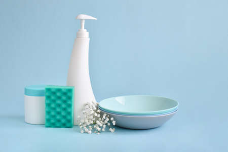 Dish detergent on a blue background. Cleaning in the house, apartment, office. Plastic packaging. Household chemicals. Different bottles of detergent. A copy of the space.の写真素材