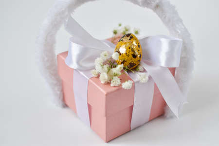 The minimal concept of Easter. A copy of the space. Pink gift box and Easter egg.