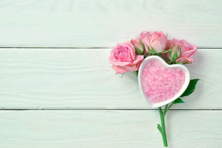 Rose branch with pink sea perfumed salt with space for text. Minimalism. SPA treatments with sea saltの写真素材