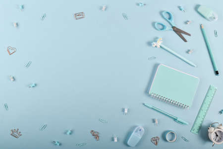 A frame of school supplies in pastel colors on a light blue background, space for text. Flat lay, top view, copy space.の写真素材