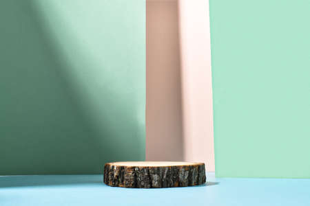 Minimalistic wooden stage on a background of geometric shadows. A podium for the presentation of goods and cosmetics. Eco-branding. An empty space.の写真素材