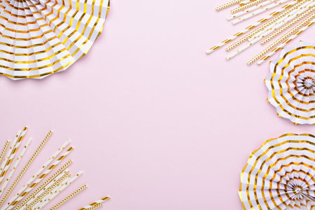 Festive pink background with gold details. Birthday or party decoration. Copy space. Flat layout, top view.の写真素材