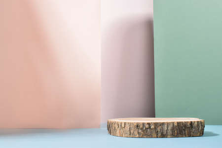 Minimalistic wooden stage on a background of geometric shadows. A podium for the presentation of goods and cosmetics. Eco-branding. An empty space.の写真素材
