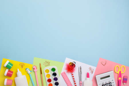 Stationery lay flat. Back to school. Various office supplies on a light blue background. Flat layout, top view, a place to copy.の写真素材
