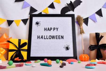 Festive decor for Halloween with pumpkins, gifts and sweets. Happy Halloween.の写真素材
