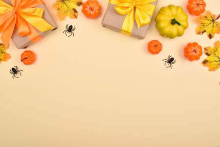 Festive Halloween background with gifts, pumpkins and spiders. Top view. Banner from the decor for the Halloween holiday.の写真素材