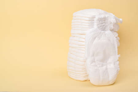 A large stack of disposable panties on a yellow background. copy spaceの写真素材