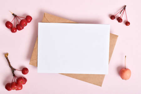 Invitation template with an envelope on a pink background with apples. A romantic note. Flat layout, top view, a place to copy.の写真素材
