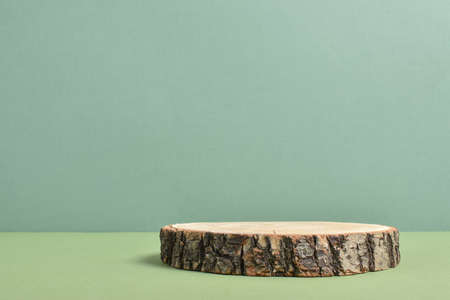 Wooden presentation stage on a beige background. The podium is made of natural material with space for text. Minimalistic branding scene.の写真素材