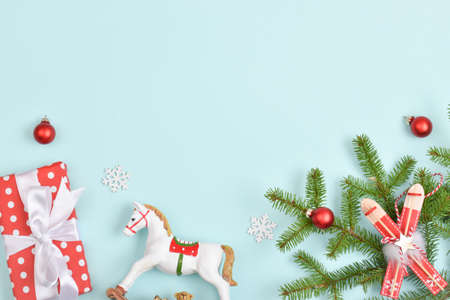 Greeting card for New Year and Christmas. A festive banner with gifts and Christmas toys on a light blue background. Flat layout, top view. Copy space.の写真素材