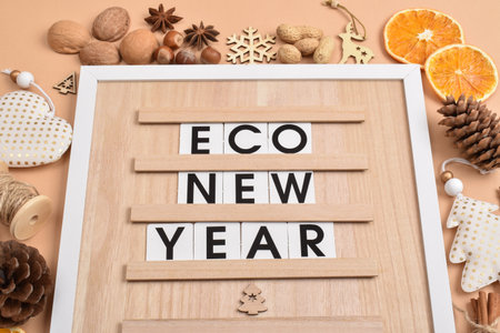 On a wooden board there is an inscription eco-new year. Natural decorations for New Year and Christmas. Ecodesign. Copy space. Flat lay, top view.の写真素材