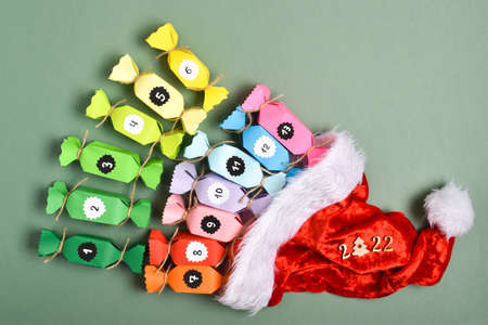 Advent calendars made of colored paper in the shape of sweets. Homemade calendar for sweets, surprises and tasks. Candy in the hat of Santa Claus and Santa Claus.の写真素材
