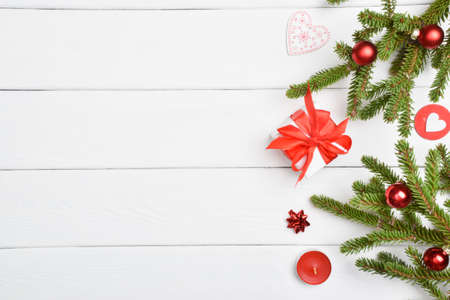 Christmas white background with gifts, glass balls and a fir branch. Copy space. Flat lay, top view.の写真素材