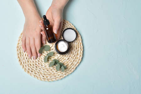 Hand and face care. Cosmetics, serum, cream. Copy space. Flat lay, top view.