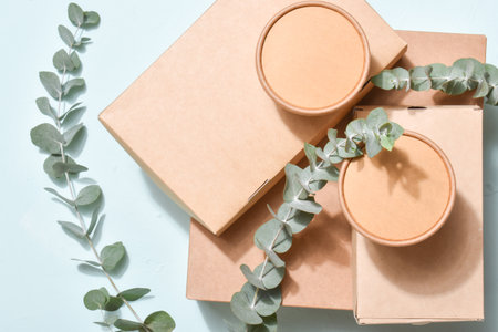 A pile of paper packaging on a neutral background. Food delivery, takeaway. Environmental...