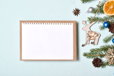One empty postcard lies on a kraft envelope on a pale blue background. Banner, invitation, layout, postcard. Flatlay, Flatlay, Flatlay, Top View, Top Viewの写真素材
